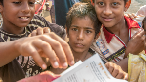 Volunteers hand out rabies vaccination forms to local people.